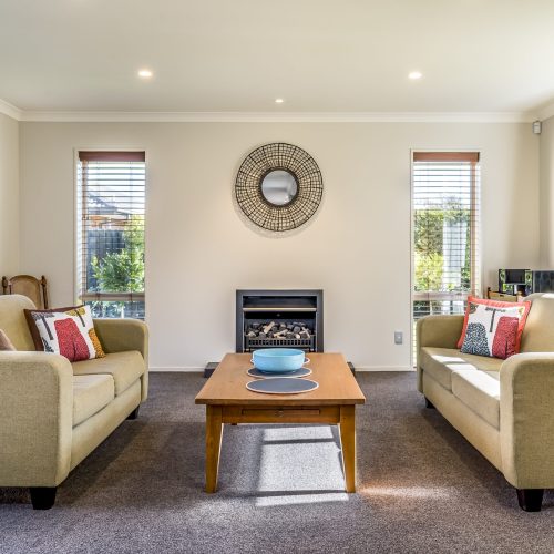 The living room of a modern apartment with two identical sofas opposite each other